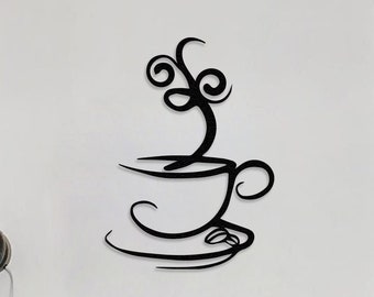 May include: Black metal wall art depicting a stylised coffee cup with steam rising from it. The art is mounted on a white wall above a wooden cabinet with bottles and glasses on top.