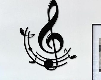 May include: Black metal wall art featuring a treble clef with musical notes. The art is displayed on a white wall above a black desk with a red chair.