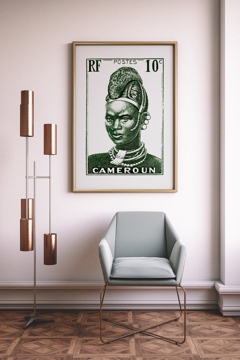 May include: A framed vintage poster with a green illustration of a woman wearing traditional African headwear and jewelry. The poster reads "RF POSTES 10c CAMEROUN".