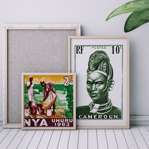 May include: Two framed vintage postage stamps. The left stamp is from Nyasaland, 1963, and depicts two people harvesting coffee beans. The right stamp is from Cameroon, 1960, and features a portrait of a woman wearing traditional headwear.