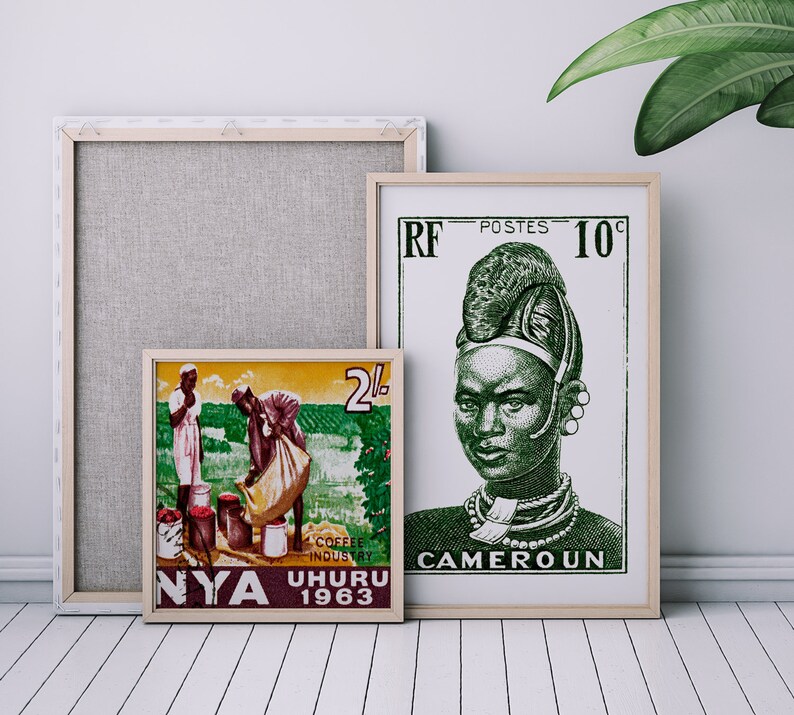 May include: Two framed vintage postage stamps. The left stamp is from Nyasaland, 1963, and depicts two people harvesting coffee beans. The right stamp is from Cameroon, 1960, and features a portrait of a woman wearing traditional headwear.