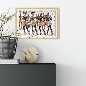 May include: A vintage postage stamp from the Republic of Congo featuring a colorful illustration of dancers in traditional costumes. The stamp reads "Folklore et Tourisme - Ballet Diaboua" and "30f Postes".