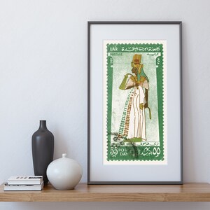 May include: A vintage postage stamp from the United Arab Republic (UAR) featuring a green background and a depiction of an Egyptian queen in a white robe with a golden headdress. The stamp has the text "UAR POSTAGE" and "55 POS DAY" in green.
