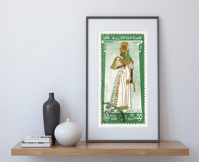 May include: A vintage postage stamp from the United Arab Republic (UAR) featuring a green background and a depiction of an Egyptian queen in a white robe with a golden headdress. The stamp has the text "UAR POSTAGE" and "55 POS DAY" in green.