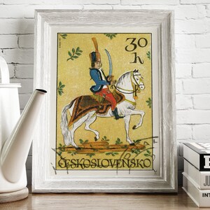 May include: A vintage Czechoslovakian postage stamp featuring a soldier on horseback. The stamp is yellow with green foliage and the text "30 K" and "CESKOSLOVENSKO".