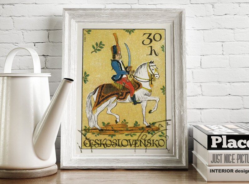May include: A vintage Czechoslovakian postage stamp featuring a soldier on horseback. The stamp is yellow with green foliage and the text "30 K" and "CESKOSLOVENSKO".