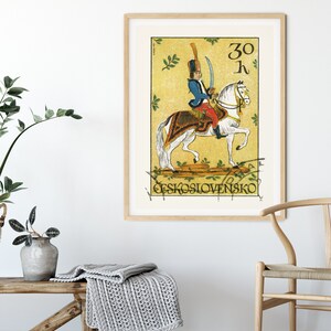 May include: A vintage Czechoslovakian postage stamp featuring a soldier on horseback. The stamp is yellow with green leaves and the text "30 h" and "CESKOSLOVENSKO".