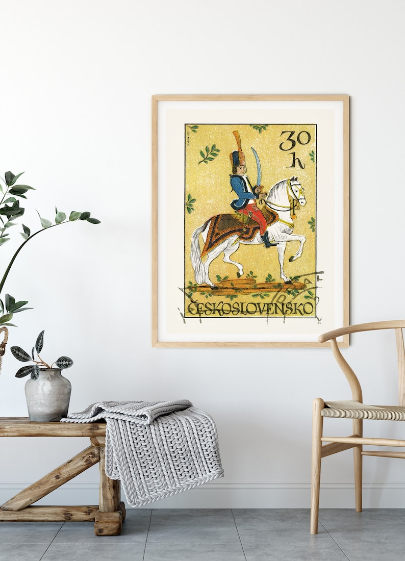 May include: A vintage Czechoslovakian postage stamp featuring a soldier on horseback. The stamp is yellow with green leaves and the text "30 h" and "CESKOSLOVENSKO".