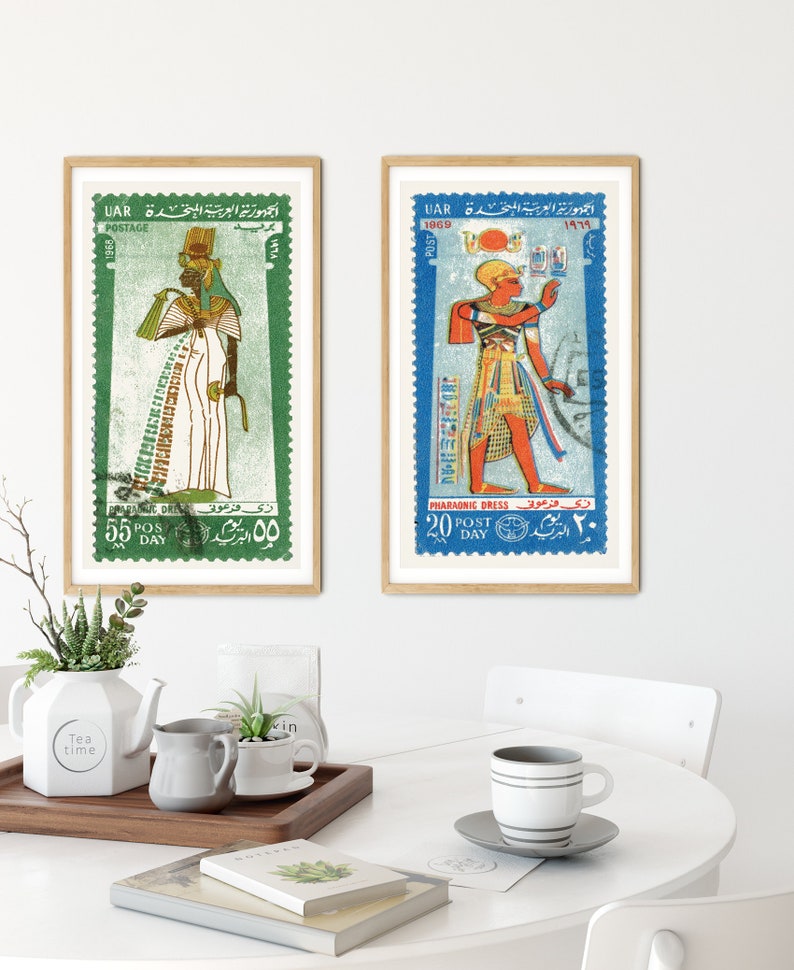 May include: Two framed vintage postage stamps featuring illustrations of Egyptian pharaohs in colorful traditional clothing. The stamps are from the United Arab Republic (UAR) and feature the text "الجمهورية العربية المتحدة" in Arabic.