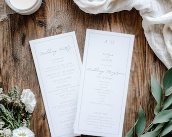 May include: Two white wedding programs with black text on a wooden surface. One program lists the wedding party, and the other has the couple's initials and names. A candle, flowers, and fabric are in the background.