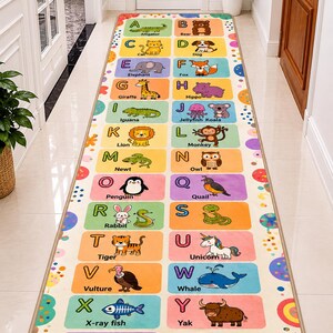 May include: A rectangular rug featuring an alphabet design with colorful illustrations of animals. Each letter has a corresponding animal, such as an alligator, bear, dog, and zebra. The rug is beige with a border of colorful polka dots.