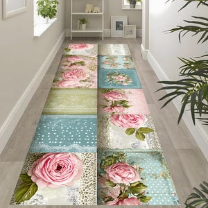 May include: A long, rectangular floral rug with a patchwork design. The rug features large pink roses, lace accents, and various pastel-colored squares, including light blue and green. The rug is designed for a hallway or entryway.