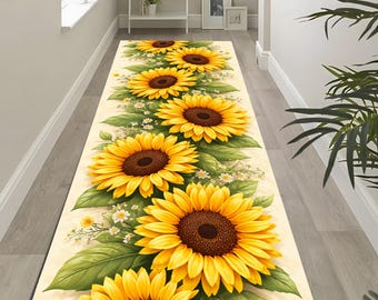 May include: A long, rectangular runner rug featuring a repeating pattern of large sunflowers with yellow petals and brown centers. Green leaves and small white flowers accent the design on a cream background. The rug is placed in a hallway.
