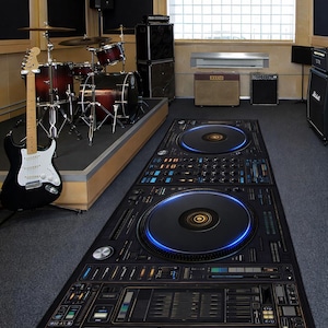 May include: A black and gold DJ-themed rug featuring two large turntable designs and control panel details. The rug is rectangular and placed on a grey floor in a music studio. A drum kit and guitar are visible.