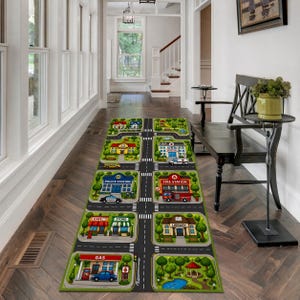 May include: A colorful play rug depicting a town scene with roads, buildings, and vehicles. The rug features a gas station, police station, fire station, cafe, store, library, and hospital. The design includes trees, a pond, and a gazebo.