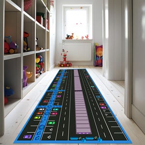 May include: A black and blue play mat with a road design and parking spaces. The mat features colorful cars and parking signs.