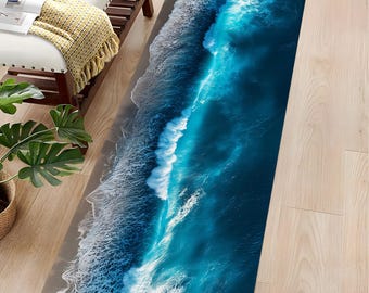 May include: A rectangular rug featuring a vibrant aerial view of ocean waves. The design showcases shades of deep blue and turquoise, with white foamy crests. The rug's edge depicts a sandy beach, creating a realistic coastal scene.