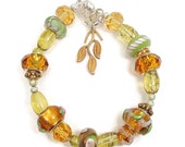 Bracelet with Lamp Worked and Large Hole Beads in Green, Amber, Olive Green and Silver with Magnetic Clasps