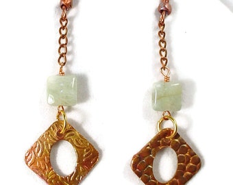 May include: A pair of copper earrings with a green stone and a textured copper square dangle. The earrings have a copper chain and a hook closure.