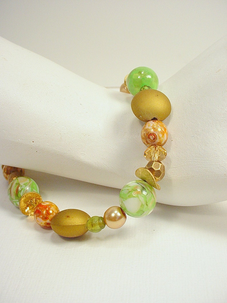 Bracelet with Crystal, Glass, Ceramic and Metal Beads in Tones of Green, Gold, and Brown with Magnetic Clasps image 1