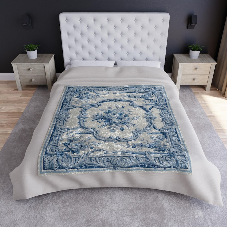 Luxury crushed velvet throw blanket featuring an antique-inspired vintage French Aubusson blue and white floral Marie Antoinette design. Soft, fluffy, comfy and cozy, this heritage design elevates home decor in any bedroom or living room. Style it on a sofa, as a bed cover or bedspread in traditional, grandmillennial, French country, or shabby chic interiors. A refined gift for art lovers.