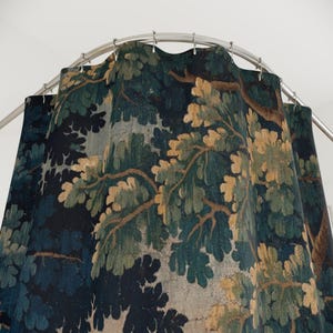 Add vintage charm to your bathroom with this stunning shower curtain, featuring a reproduction of an 18th-century Aubusson verdure tapestry. The lush woodland scene brings antique elegance to your bathroom decor, making it a perfect centerpiece for any bathroom renovation. Crafted from high-quality fabric, this bath curtain combines historic beauty with everyday functionality. Elevate your home decor with this unique tapestry-inspired bathroom accessory.