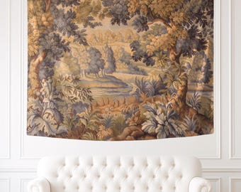 May include: A rectangular wall tapestry featuring a woven landscape scene with large trees in the foreground framing a river, rolling hills, and distant buildings. The color palette consists of muted shades of blue, green, and tan.