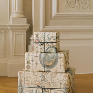 Wrap your presents this Christmas holiday season in elegance with this vintage French chateau neoclassical design. Featuring intricate details, this antique-style wrap adds sophistication to any gift packaging. Perfect for DIY projects, scrapbooking, art supplies, and crafting, this high-quality paper roll enhances any occasion with its timeless charm. Elevate your gift wrap with historic beauty and luxurious packaging.