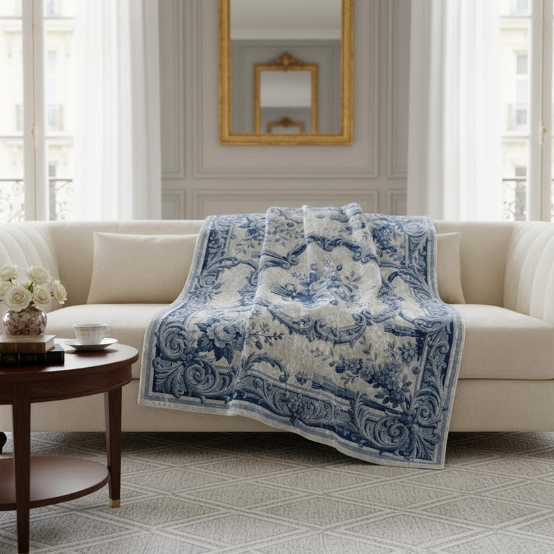 Luxury crushed velvet throw blanket featuring an antique-inspired vintage French Aubusson blue and white floral Marie Antoinette design. Soft, fluffy, comfy and cozy, this heritage design elevates home decor in any bedroom or living room. Style it on a sofa, as a bed cover or bedspread in traditional, grandmillennial, French country, or shabby chic interiors. A refined gift for art lovers.