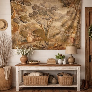 Bring timeless charm to your home with this 19th-century French verdure garden tapestry wall hanging. Featuring pastoral scenes, elegant figures, and lush foliage, this antique-style Aubusson piece adds a grandmillennial touch to any room. Perfect for French country, cottagecore, or vintage decor. Ideal for a living room, bedroom, or hallway. A statement piece for lovers of historic wall art, tapestries, and château interiors.