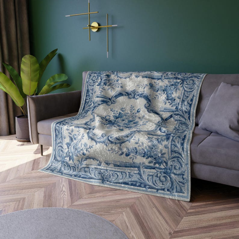 Luxury crushed velvet throw blanket featuring an antique-inspired vintage French Aubusson blue and white floral Marie Antoinette design. Soft, fluffy, comfy and cozy, this heritage design elevates home decor in any bedroom or living room. Style it on a sofa, as a bed cover or bedspread in traditional, grandmillennial, French country, or shabby chic interiors. A refined gift for art lovers.