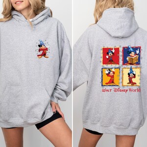 May include: A grey hooded sweatshirt with a Mickey Mouse illustration on the front and a larger Mickey Mouse illustration on the back. The back illustration features Mickey Mouse in four different poses, each in a different coloured square. The text "WALT DISNEY WORLD" is printed below the squares.