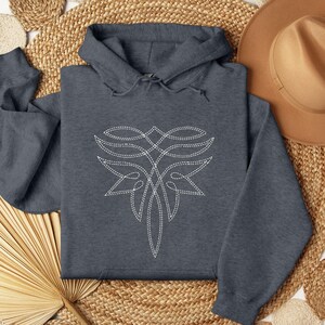 Puede incluir: Sudadera con capucha gris oscuro con un dise&ntilde;o floral blanco y estilizado en la parte delantera. El dise&ntilde;o est&aacute; hecho de l&iacute;neas cosidas. La sudadera tiene una capucha con cord&oacute;n.
