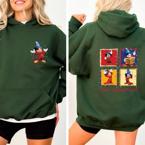 May include: A dark green hooded sweatshirt with a Mickey Mouse graphic on the front and a Mickey Mouse graphic with the text "Walt Disney World" on the back.