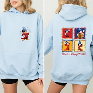 May include: Light blue hooded sweatshirt with a Mickey Mouse graphic on the front and a four-panel Mickey Mouse graphic on the back. The back graphic includes the text "Walt Disney World".