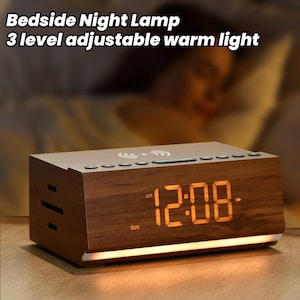 May include: A wooden bedside alarm clock with a warm white LED display showing the time as 12:08 AM. The clock has a built-in wireless charging pad and a three-level adjustable warm light.