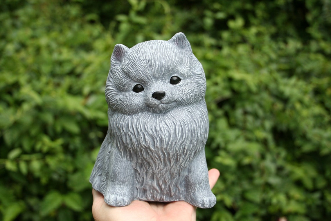 pomeranian statue with wings