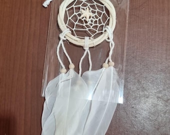 May include: A small dreamcatcher with a woven circular frame, a central star, and hanging white feathers. The dreamcatcher is made of natural materials and is designed for decorative purposes.