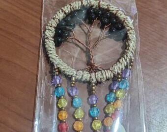 May include: A handmade keychain featuring a dreamcatcher design. The circular frame is wrapped in natural twine, with a copper wire tree in the center. Colorful beads and white seashells hang below, with a silver keyring at the top.
