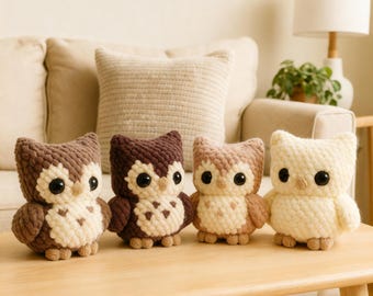 May include: Four handmade crochet owl figurines in varying shades of brown and cream sit on a wooden table. Each owl has large black eyes and a textured, fluffy appearance. The owls are a charming decorative item.