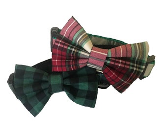 May include: A green and black plaid bow tie and a red, white, and green plaid bow tie attached to a green adjustable dog collar.