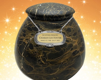 May include: Black and gold marble urn with a silver plaque that reads "In Loving Memory Charles Lee Foster March 12, 1948 - July 9, 2022".