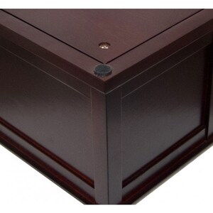 May include: A dark brown wooden box with a decorative trim around the edges. The box has a smooth, polished finish and features black felt pads on the bottom.