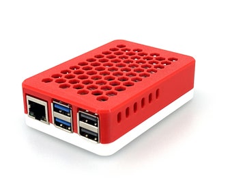 May include: Red and white plastic case with a honeycomb pattern on the top and a white base. The case has a network port, two USB ports, and a micro USB port.