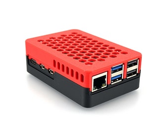 May include: Red and black Raspberry Pi case with a honeycomb pattern on the top and ports on the side.