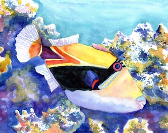 May include: A watercolor painting of a yellow, black, and white fish with a red and blue eye, swimming near coral. The fish has a large, round body and a small mouth. The coral is a vibrant purple and blue color.