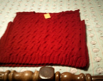 Sleeveless red vest with cables