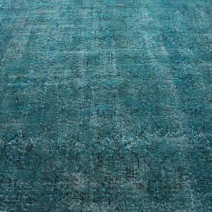 May include: A teal blue rug with a faded, distressed pattern. The rug has a vintage look and feel.