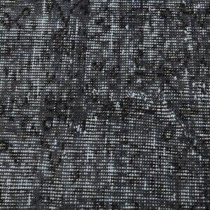 May include: A close-up of a black and white patterned rug with a textured surface.