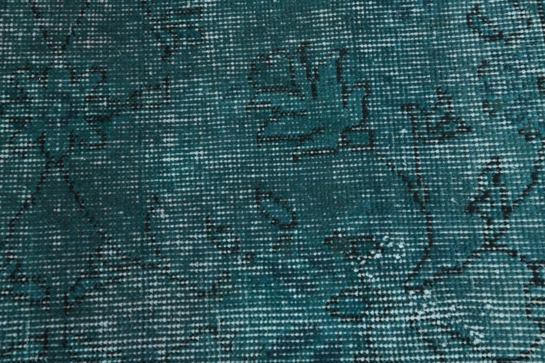 May include: Teal blue fabric with a woven pattern. The fabric has a subtle, faded design.